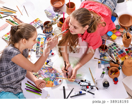 Authentic artist children girl paints on floor 38918193