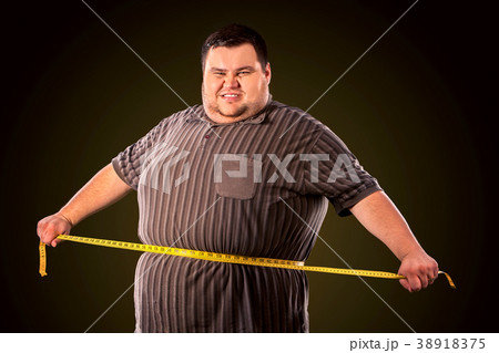 Man belly fat with tape measure weight loss around 38918375