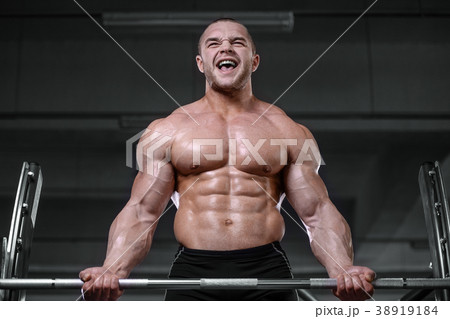 Brutal strong bodybuilder athletic men pumping up muscles with d Brutal strong bodybuilder athletic men pumping up muscles with d 38919184