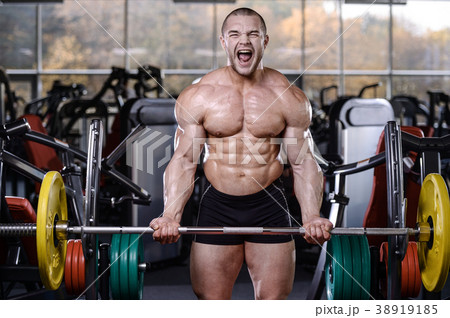 Brutal strong bodybuilder athletic men pumping up muscles with d Brutal strong bodybuilder athletic men pumping up muscles with d 38919185
