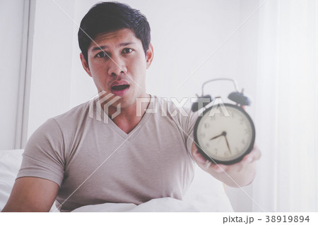 Man just got up and shocked with late alarm clock Man just got up and shocked with late alarm clock 38919894