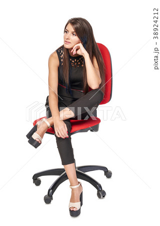 Woman sitting on office chair looking to side Woman sitting on office chair looking to side 38924212