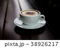 Coffee in a white cup on a wooden table. 38926217