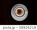 Coffee in a white cup on a wooden table. 38926218