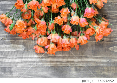 Bouquet of orange roses on wooden plank. Bouquet of orange roses on wooden plank. 38926452
