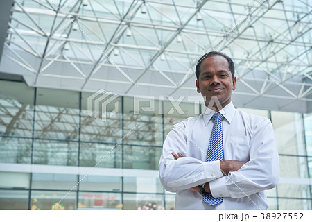 Cheerful Indiian businessman Cheerful Indiian businessman 38927552