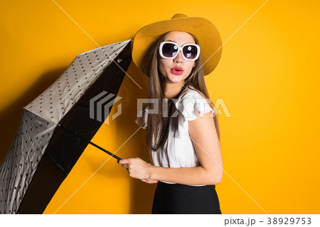 girl  in sunglasses and fashionable hat posing 38929753