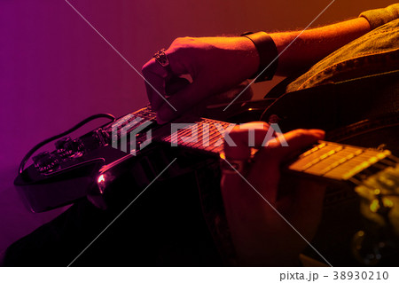 Electric guitar player on a stage Electric guitar player on a stage 38930210
