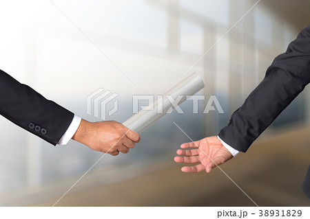 businessman passing relay baton to colleague businessman passing relay baton to colleague 38931829