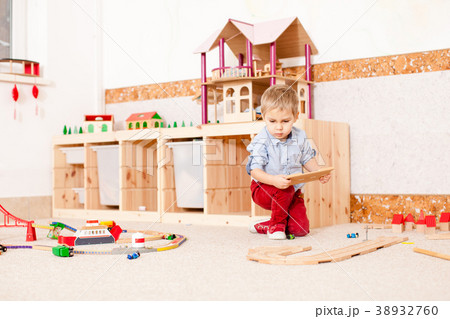 Boy plays with train Boy plays with train 38932760