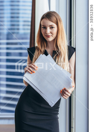 Portrait of pretty smiling young woman holding 38932836