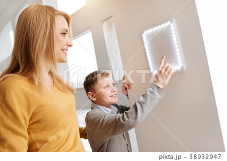 Happy nice boy looking at the control panel 38932947