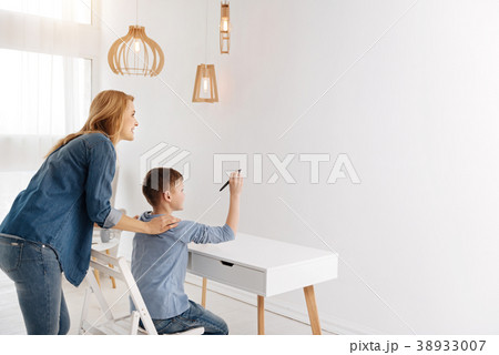 Cute delighted boy using progressive technology 38933007
