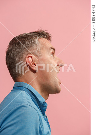 The young emotional angry man screaming on pink 38934743