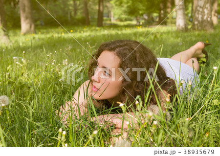 Woman having rest on meadow Woman having rest on meadow 38935679