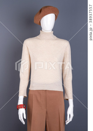 White sweater and brown trousers on mannequin. White sweater and brown trousers on mannequin. 38937557