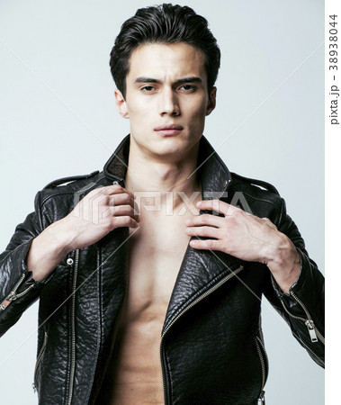 young handsome man, leather jacked on naked torso young handsome man, leather jacked on naked torso 38938044