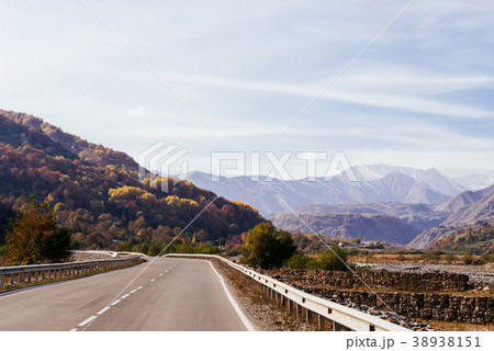road at the foot of the mountains, the slopes 38938151