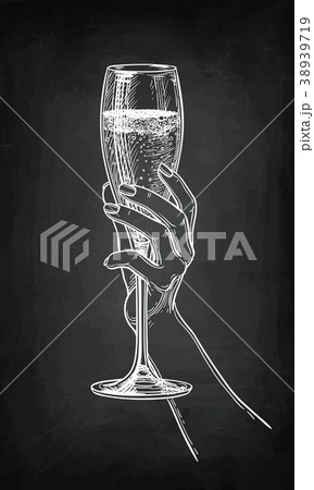 Hand holding a glass of champagne. Hand holding a glass of champagne. 38939719