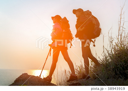 Successful Hiker women hiking with backpack Successful Hiker women hiking with backpack 38943919
