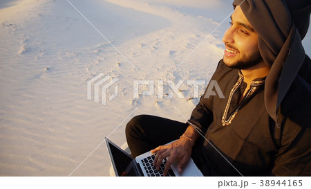 Educated Arab student uses laptop and works 38944165