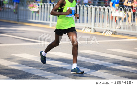 marathon runner legs running on city road marathon runner legs running on city road 38944187