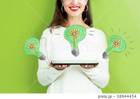 Eco Energy with woman holding a tablet 38944454