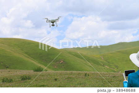 woman photographer flying drone outdoors woman photographer flying drone outdoors 38948688