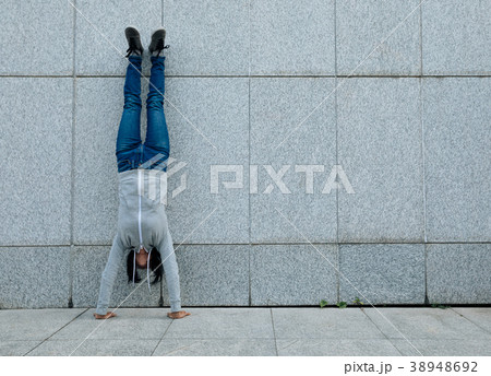 female doing a handstand against wall 38948692