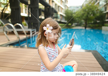 kid girl make photo on tablet sitting close to kid girl make photo on tablet sitting close to 38949424