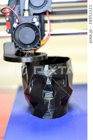 3D printer printing a model in the form of black 38952321