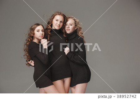 The fashion girls standing together and looking at 38952742