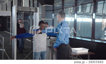 Diverse passengers passing security control 38955660