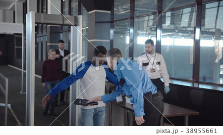 Diverse passengers passing security control Diverse passengers passing security control 38955661