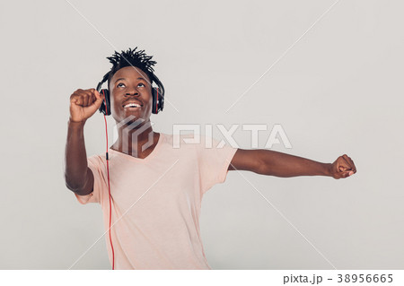 African American man in headphones listening to 38956665