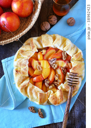 Yellow plums tart galette with walnuts and honey 38962423