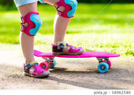 Child riding skateboard in summer park Child riding skateboard in summer park 38962580
