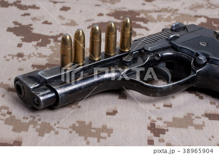 Beretta hand gun on  desert marines uniform 38965904