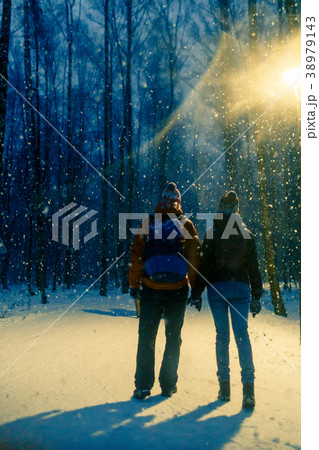Photo from back of young couple in winter park Photo from back of young couple in winter park 38979143