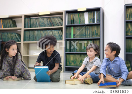 Happy kids reading on the floor. Happy kids reading on the floor. 38981639