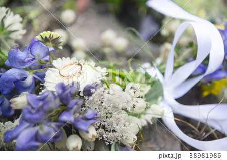 Wedding ring with a diamond lies on a wedding Wedding ring with a diamond lies on a wedding 38981986