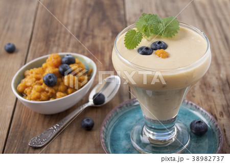 Smoothies with cloudberries  and a blueberry 38982737