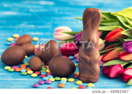 chocolate rabbit, easter eggs and tulips 38983467