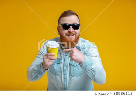 red beard man holding cup with coffee red beard man holding cup with coffee 38986112