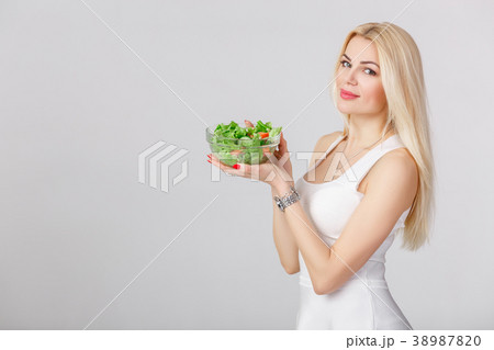 woman in white dress with fresh salad woman in white dress with fresh salad 38987820
