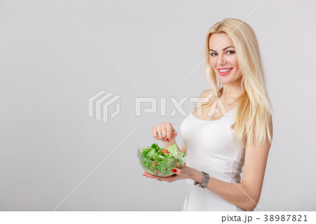 woman in white dress with fresh salad woman in white dress with fresh salad 38987821
