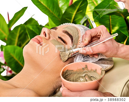 Mud facial mask of woman in spa salon. Face 38988302
