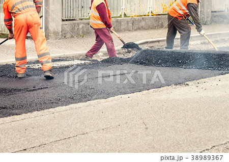 Workers on Asphalting paver machine during Road  38989367