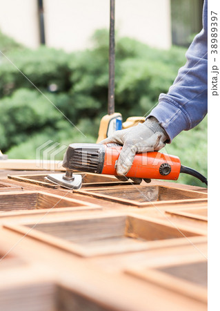 Carpenter at work with angular Sander. 38989397