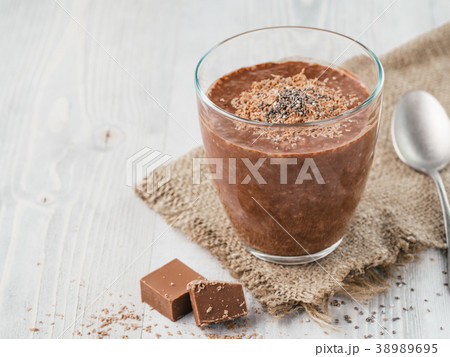 Chocolate chia pudding in glass on gray table Chocolate chia pudding in glass on gray table 38989695